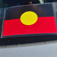 Load image into Gallery viewer, Flag with a yellow circle on a red background, placed on a reflective surface.
