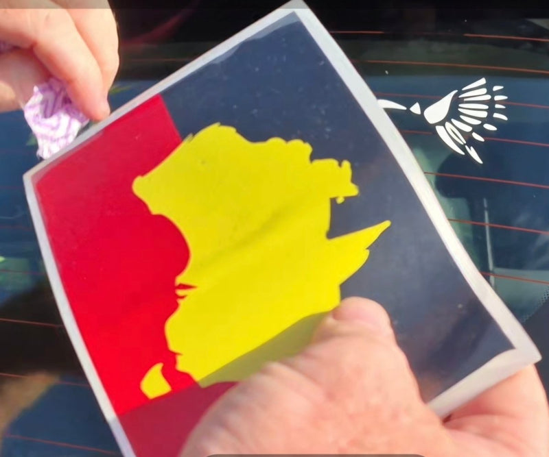 Person holding a card with a yellow silhouette on a red and blue background