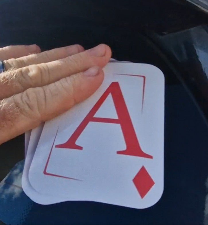 Hand holding aces with a blurred background