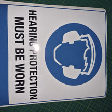 Load image into Gallery viewer, Adhesive vinyl Sign with a hearing protection symbol and text on a cutting mat
