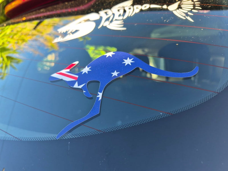 Blue kangaroo-shaped sticker with Australian flag on a car window