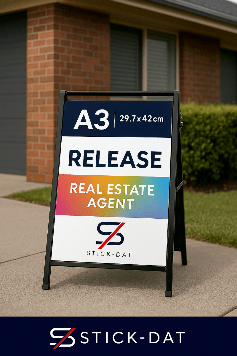 Outdoor sign for a real estate agent with 'Stick-Dat' branding in front of a house.