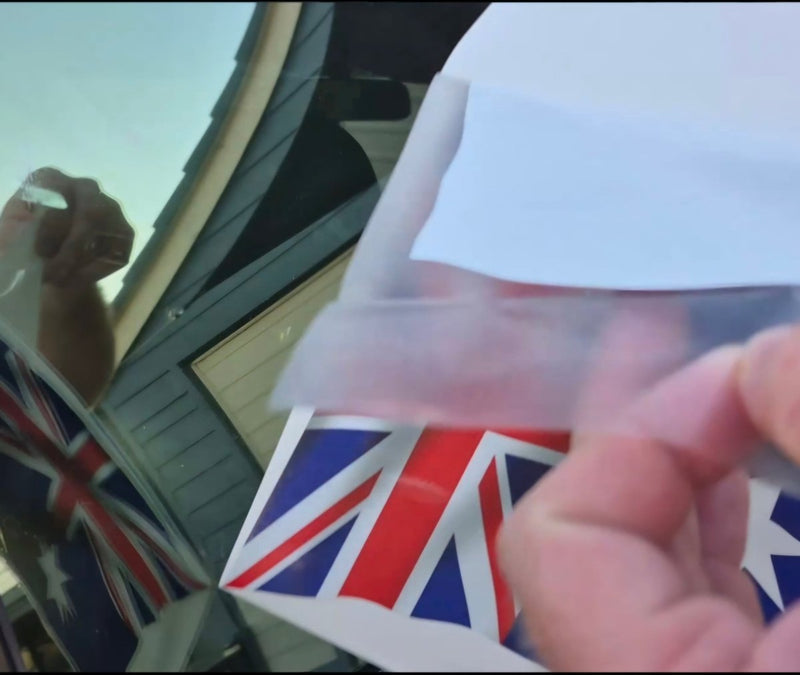 Person holding a clear allocation tape with a Union Jack design, australuan flag decal