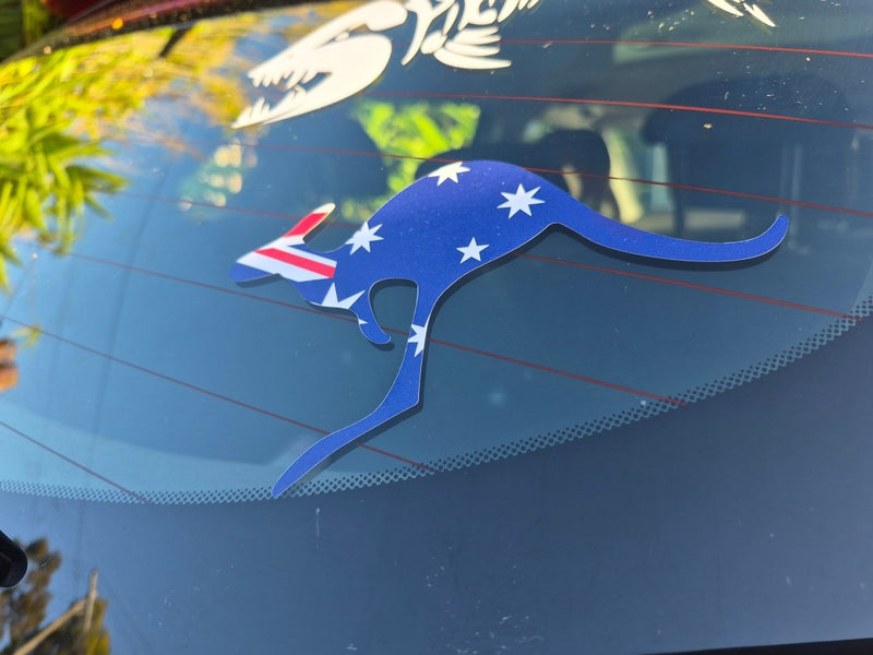 Blue kangaroo-shaped decal with Australian flag design on a car window.