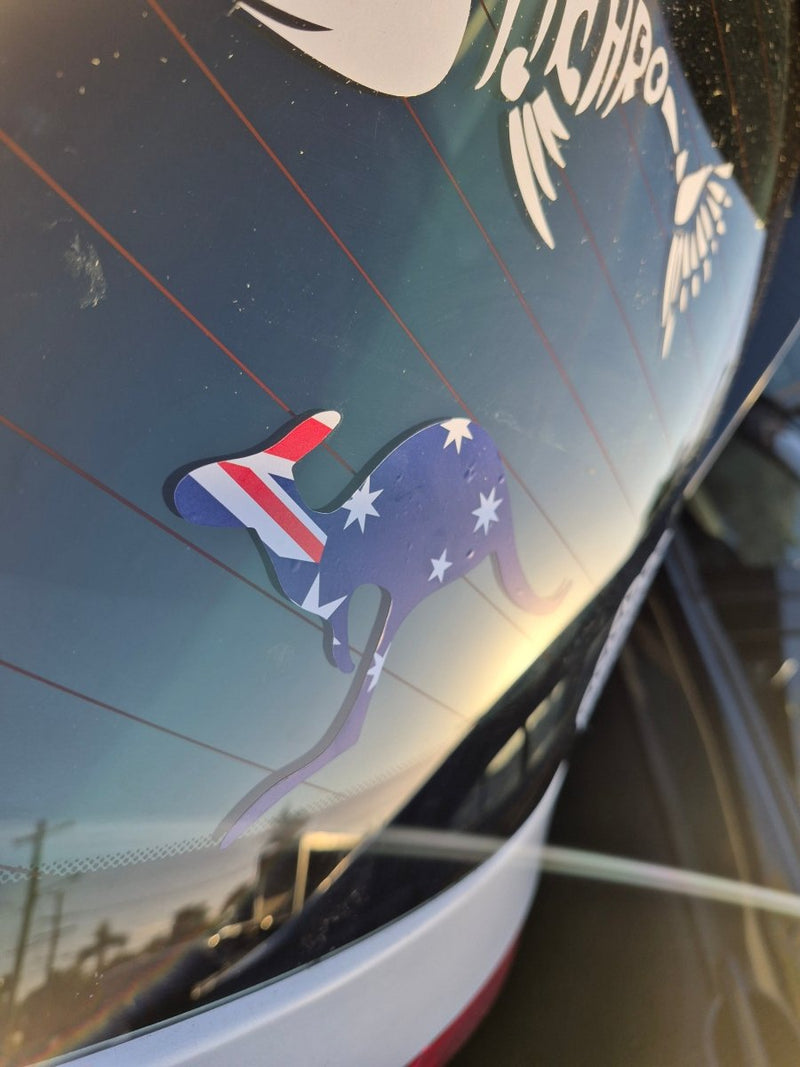 Car window with a decorative decal of a cat with Australian flag  colors