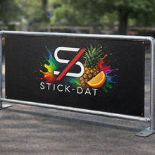 Load image into Gallery viewer, Outdoor setting with a 'Stick-Dat' branded banner featuring colorful graphics.
