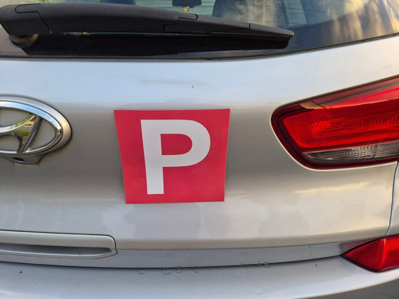 Car with a red 'P' plate Magnets on the back, indicating a Provisional driver.