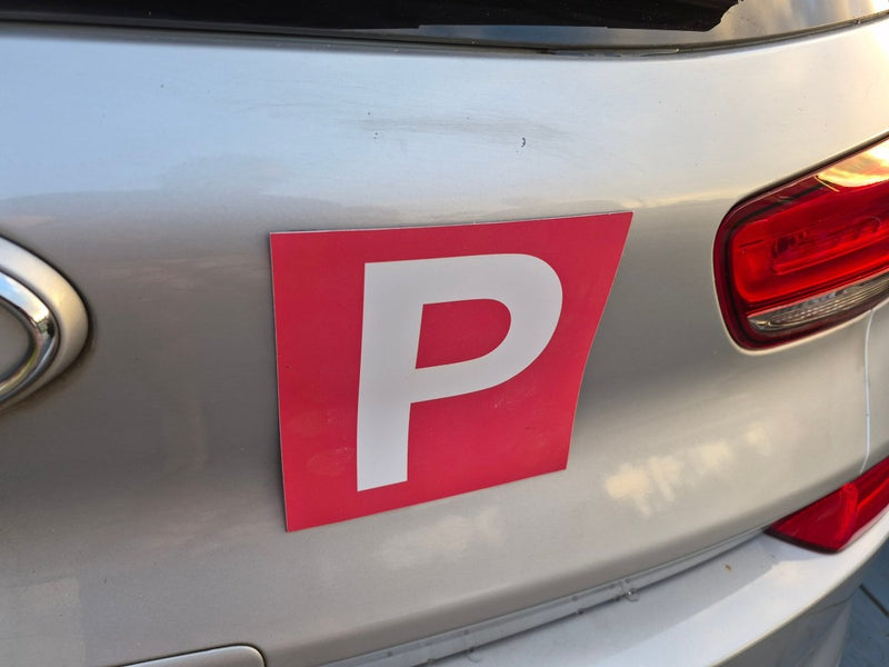 Red 'P' plate Magnets on a car's rear indicating it is a Provisional driver vehicle.