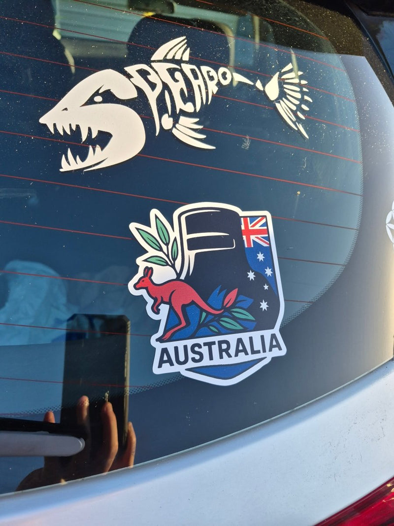 Car window with a kangaroo and emu decal on the left and an Australia decal on the right. Ned Kelly