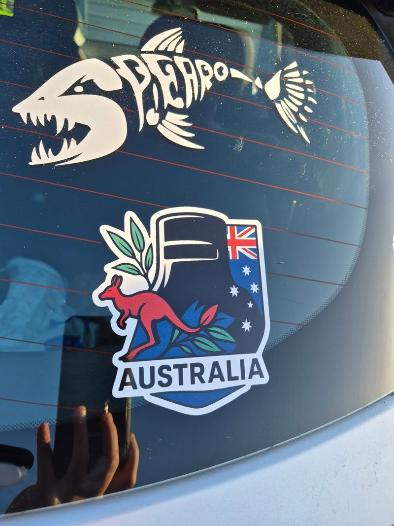 Car window with two decals, one featuring a kangaroo and the other,Ned Kelly dark background 