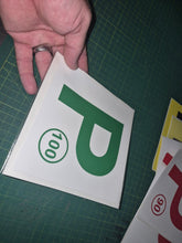 Load image into Gallery viewer, Hand holding a green 'P' with number 100 on a white background, on a green cutting mat.
