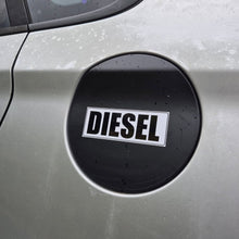 Load image into Gallery viewer, A close-up of a silver car door featuring a black circular fuel door cover with a white and black DIESEL label.

