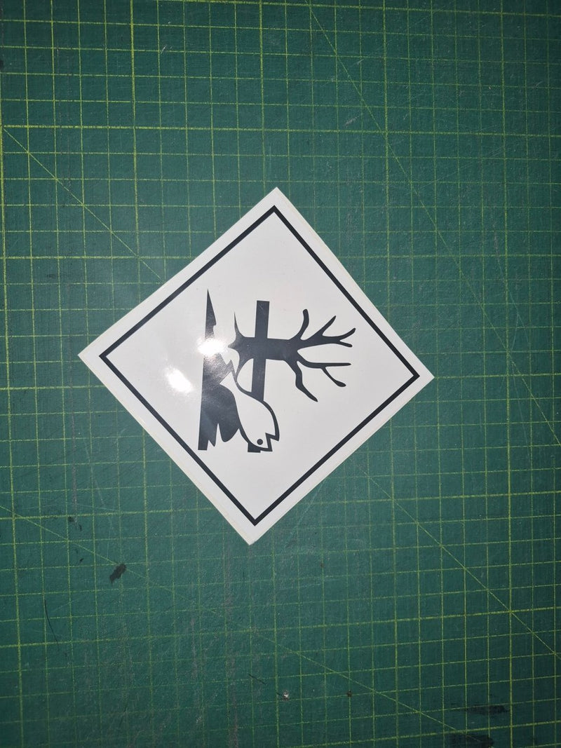 Sticker of a fish with a tree and log on a green cutting mat