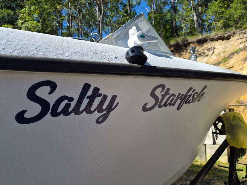 White boat with custom made name 'Salty Starfish' decal on a natural background in australia