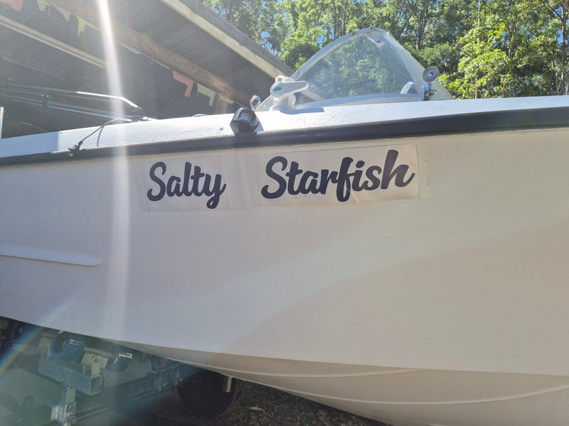 Boat with 'Salty Starfish' decal on a sunny day in Australia 
