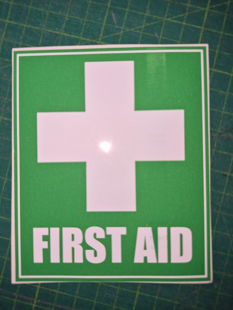 First aid sign with a cross on a green background