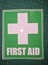 Load image into Gallery viewer, First aid sign with a cross on a green background
