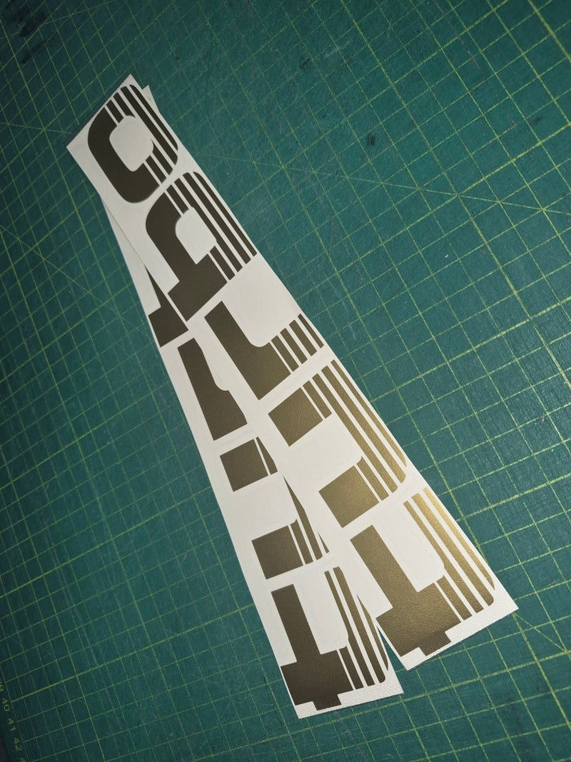 Turbo decal on a green cutting mat with grid lines