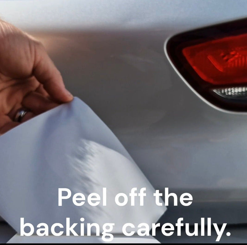Green provisional stickers Person peeling off a car wrap with text 'Peel off the backing carefully' on a car's rear light.