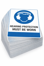 Load image into Gallery viewer, Stack of 'Hearing protection must be worn' signs with a blue and white design.
