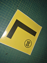 Load image into Gallery viewer, Yellow square with a black 'L' and a black circle with number 90 on a green grid background
