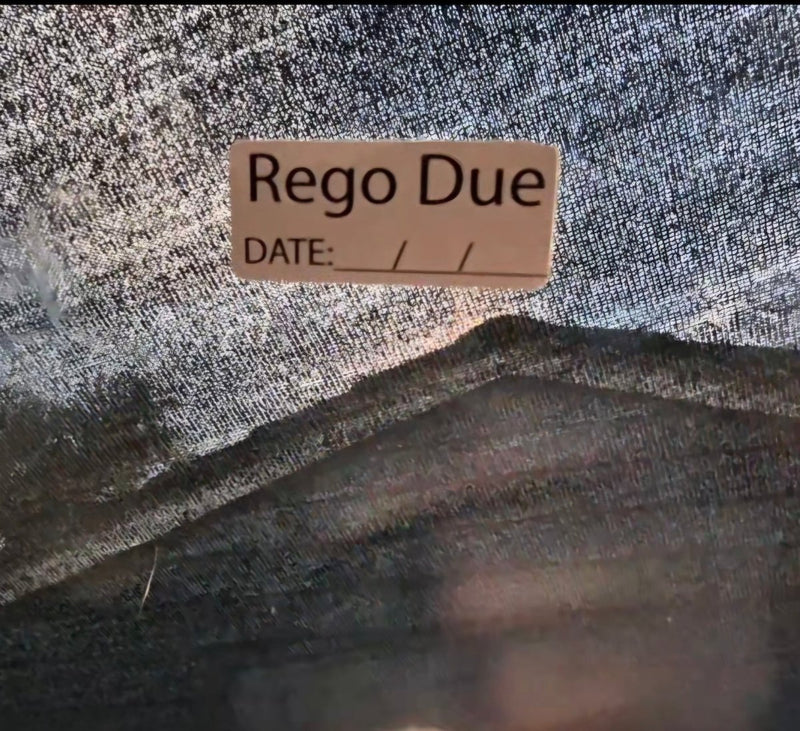 Label with 'Rego Due' text on a textured fabric background