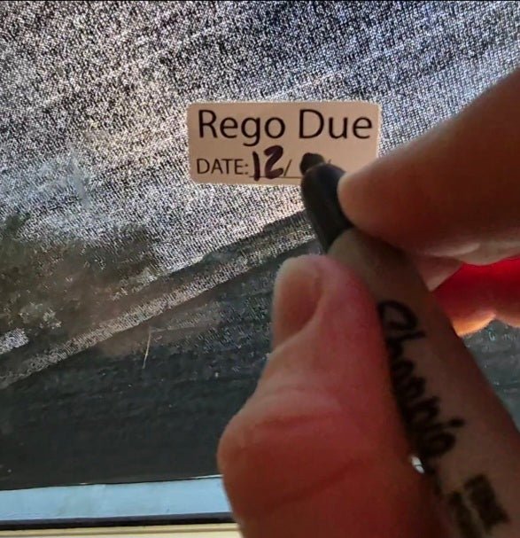 Hand holding a marker with 'Rego Due' text over a textured surface