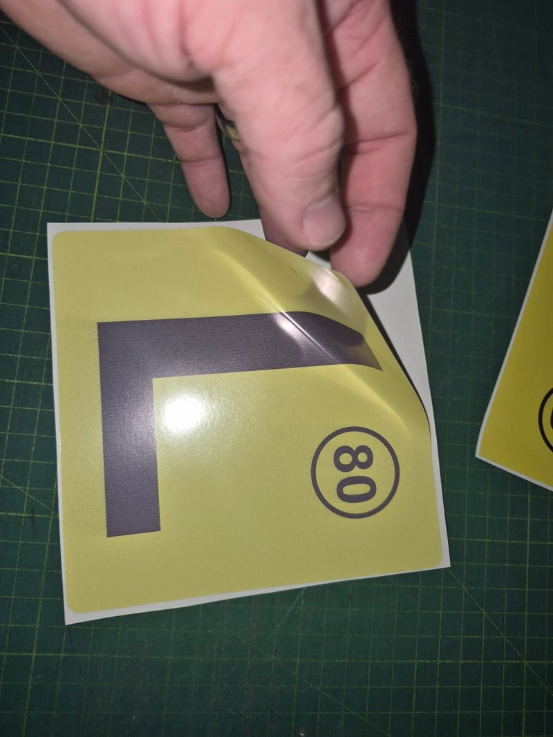 Yellow traffic sign with number 80 on a green cutting mat
