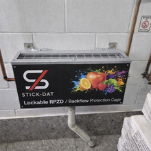 Load image into Gallery viewer, Lockable RPZD/backflow protection cage with Stick-Dat branding on a tiled wall.
