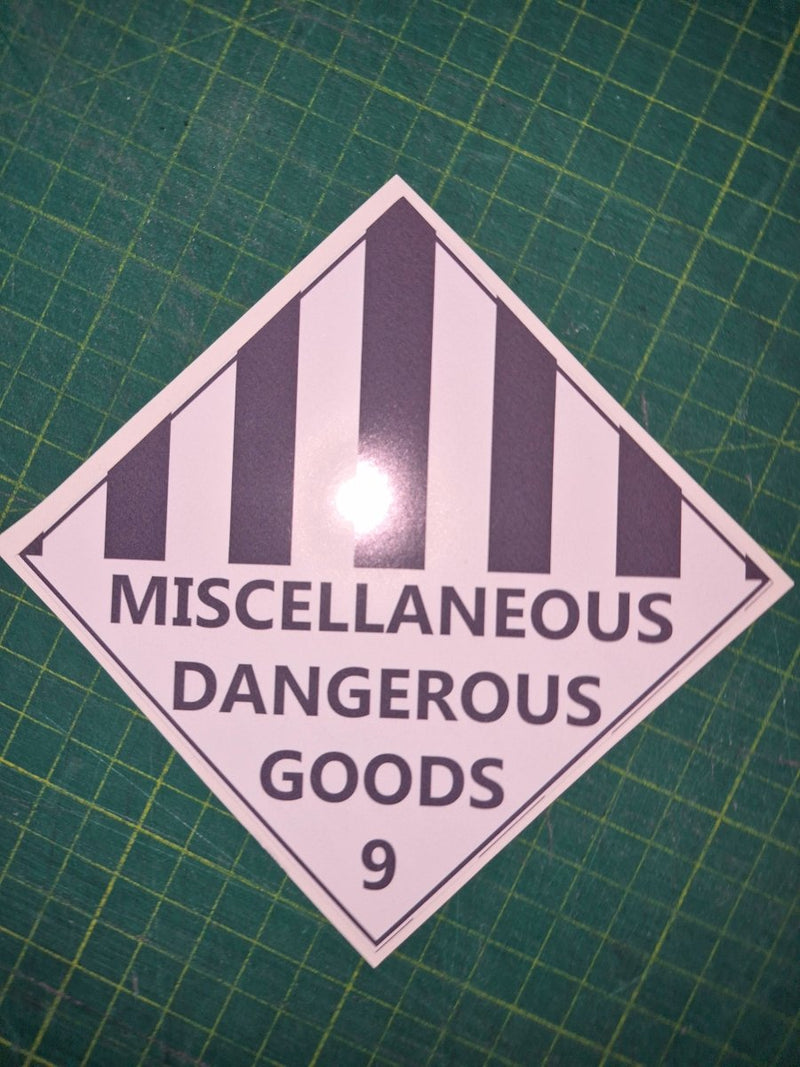 Diamond-shaped label with 'Miscellaneous Dangerous Goods' text on a green grid background