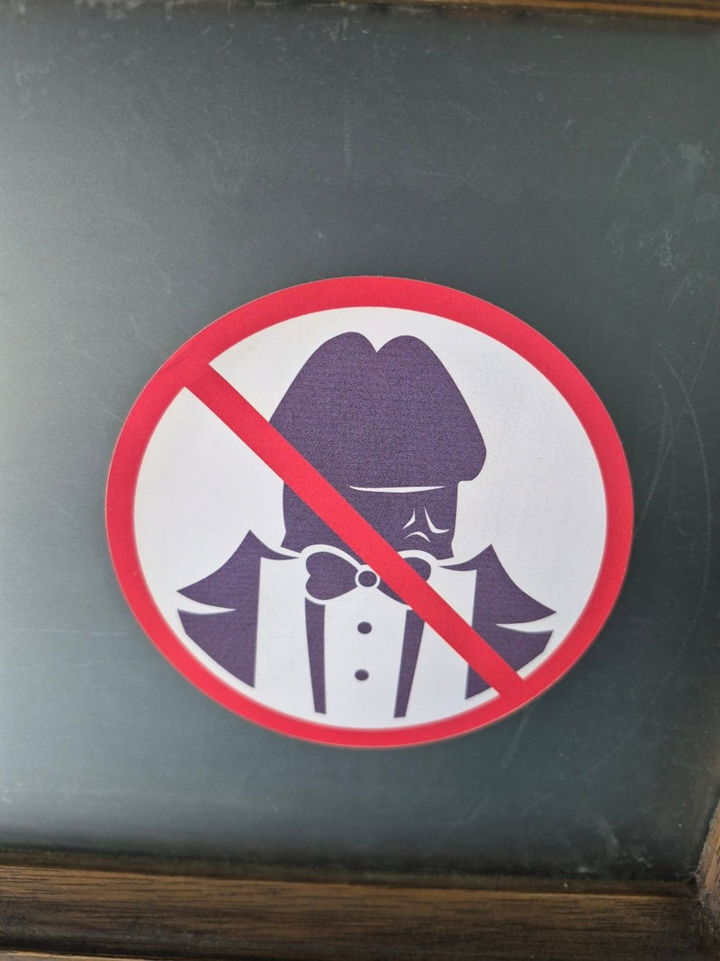 Prohibition No Dickheads Allowed sticker with a red circle and diagonal line over an illustration of a person smoking, on a dark background.