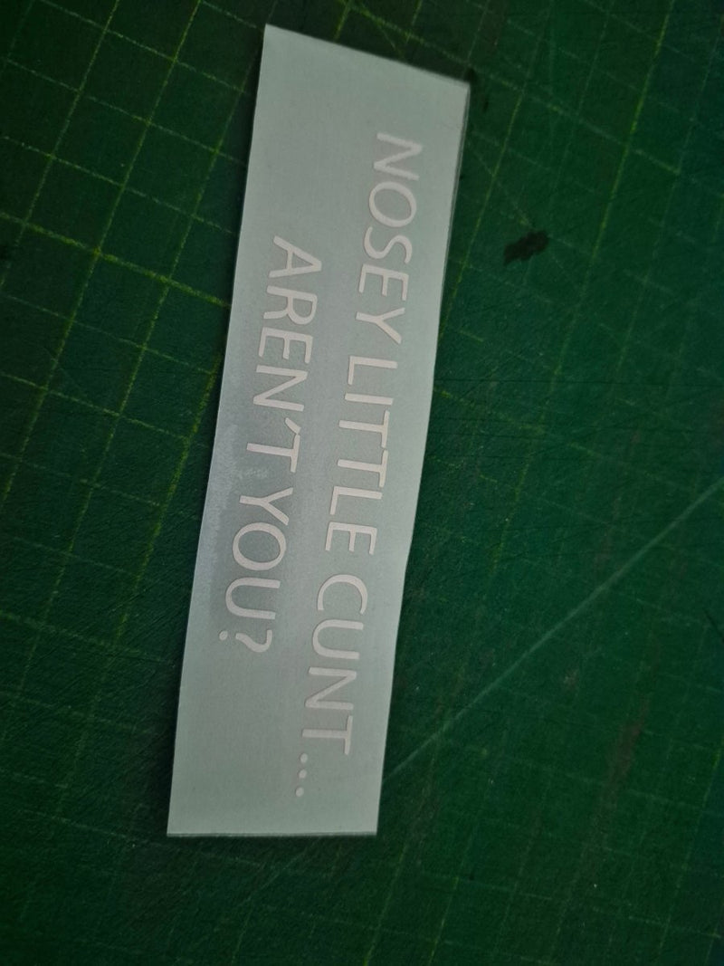 Clear decal with text on a green cutting mat