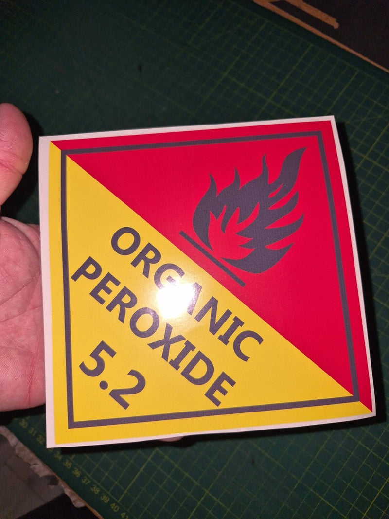 hand holding a Organic peroxide decal