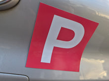 Load image into Gallery viewer, Red and white 'P' plate on a car, indicating a learner driver.
