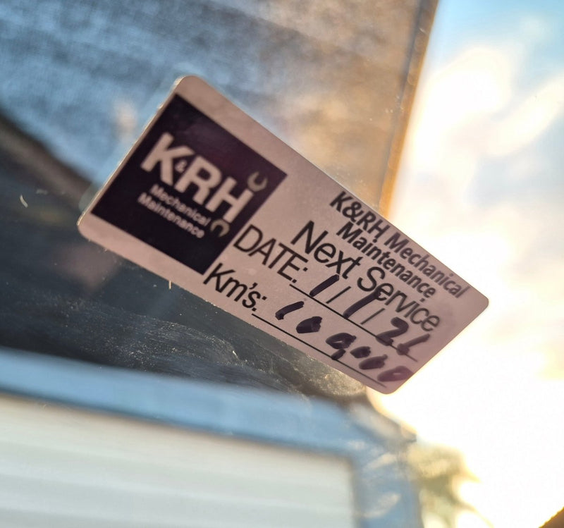 Real customers logo on our service due K&RH Mechanical Maintenance sticker on a car window with service details.