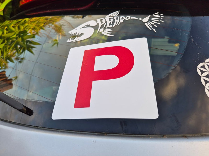 Red 'P' plate Sticker on a car window with a white decal of a fish.