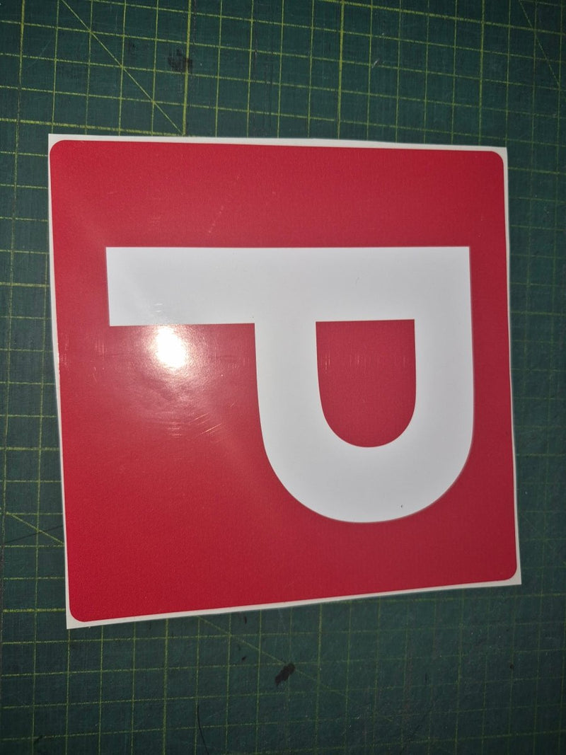 Red square with a white 'P' on a green cutting mat