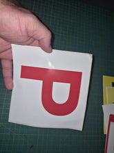 Load image into Gallery viewer, Hand holding a red 'P' on a white background against a green cutting mat.
