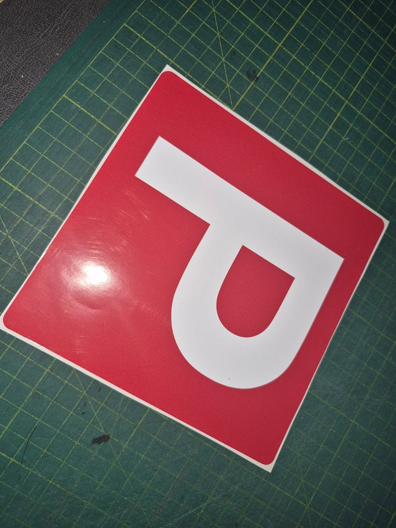 Red square with a white 'P' on a green grid background
