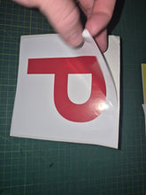 Load image into Gallery viewer, Red 'P' sticker held over a white square on a green cutting mat.
