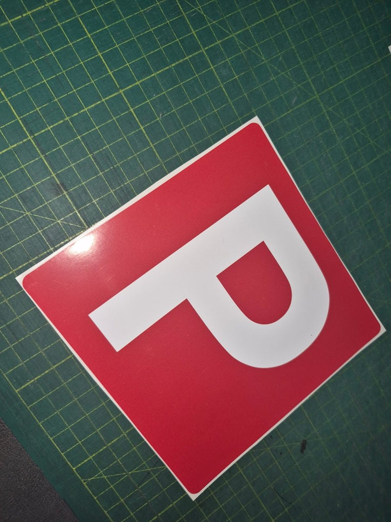 Red square with a white 'P' on a green grid background