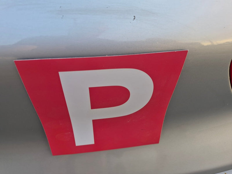 Red square Magnets with a white 'P' on a vehicle