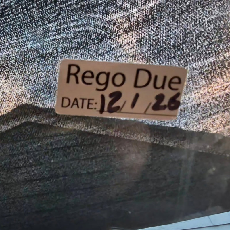 Label with 'Rego Due' and a date on a textured surface