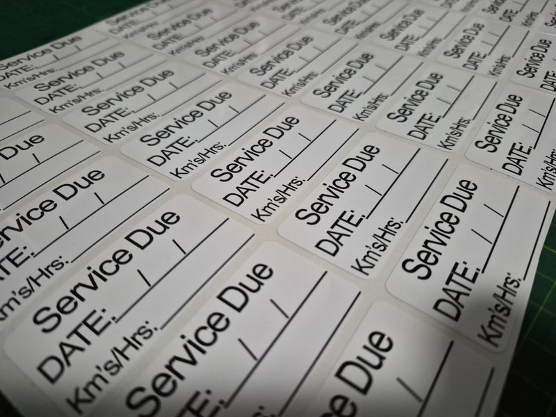 Sheet of labels with 'Service Due' and other text on a white background