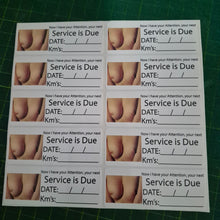 Load image into Gallery viewer, Sheet of printed labels with 'Service is Due' text and images on a green cutting mat.
