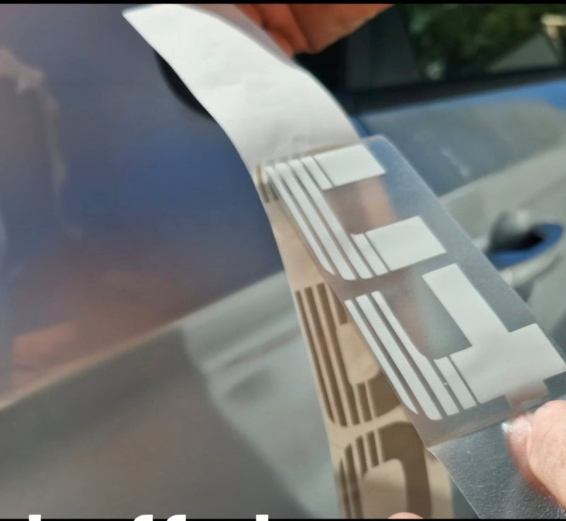 Person applying a car wrap film with a logo on a vehicle Silver tubro decals