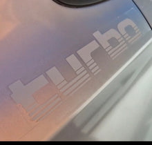 Load image into Gallery viewer, Close-up of a 'Turbo' decal on a vehicle's surface.
