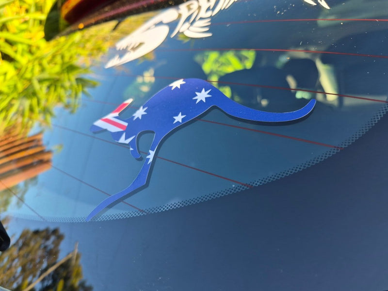 Blue kangaroo-shaped decal with Australian flag on a car window