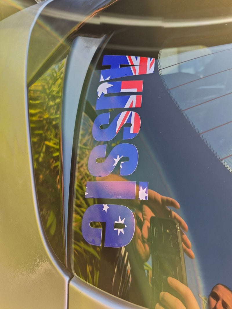 Car window with 'AUSSIE' decal featuring Australian flag design