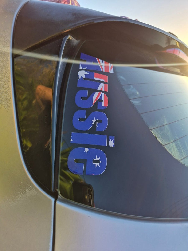 Car window with 'Aussie' decal featuring the Australian flag